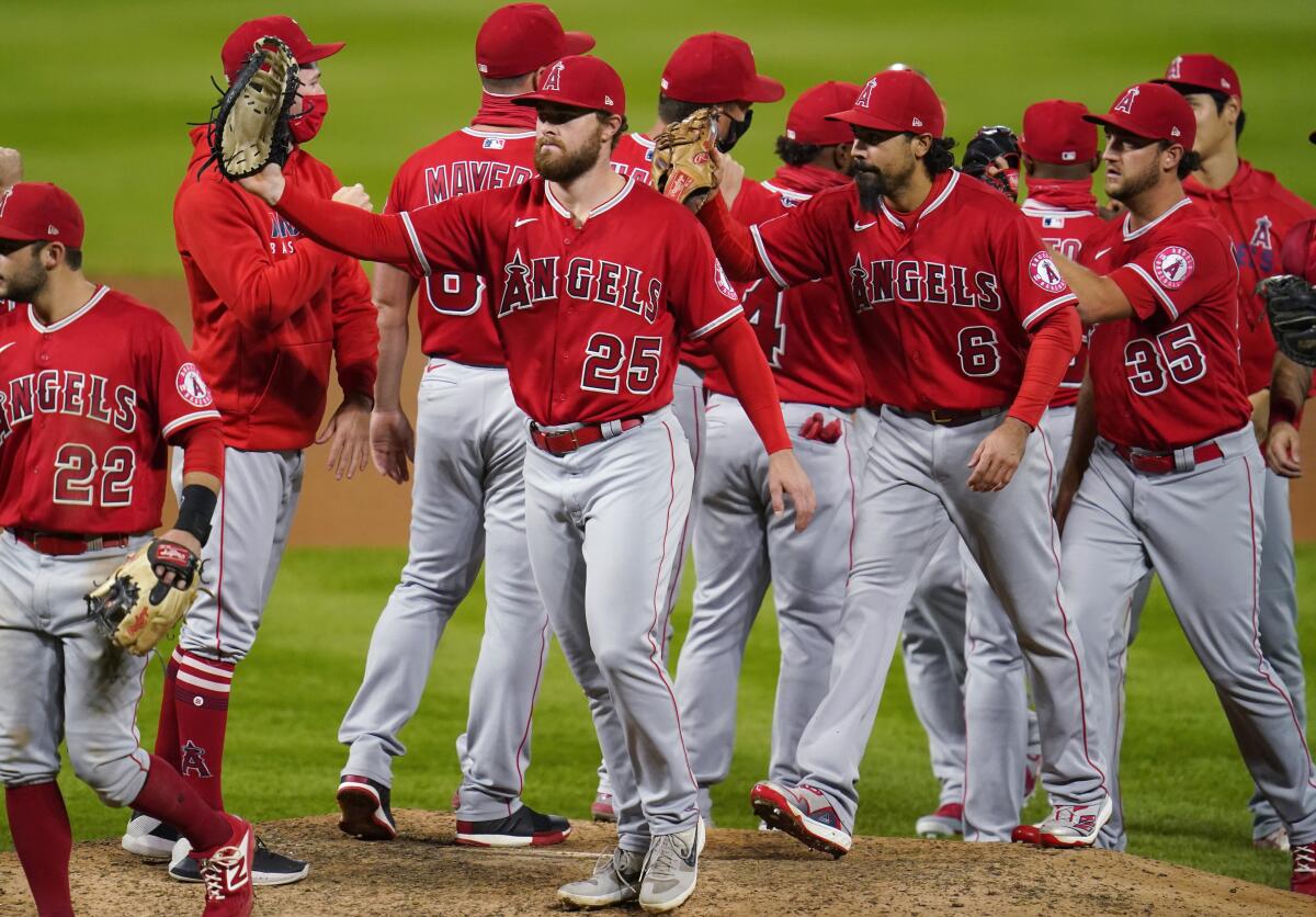 Los Angeles Angels first baseman Jared Walsh celebrates with teammates after a baseball game.
