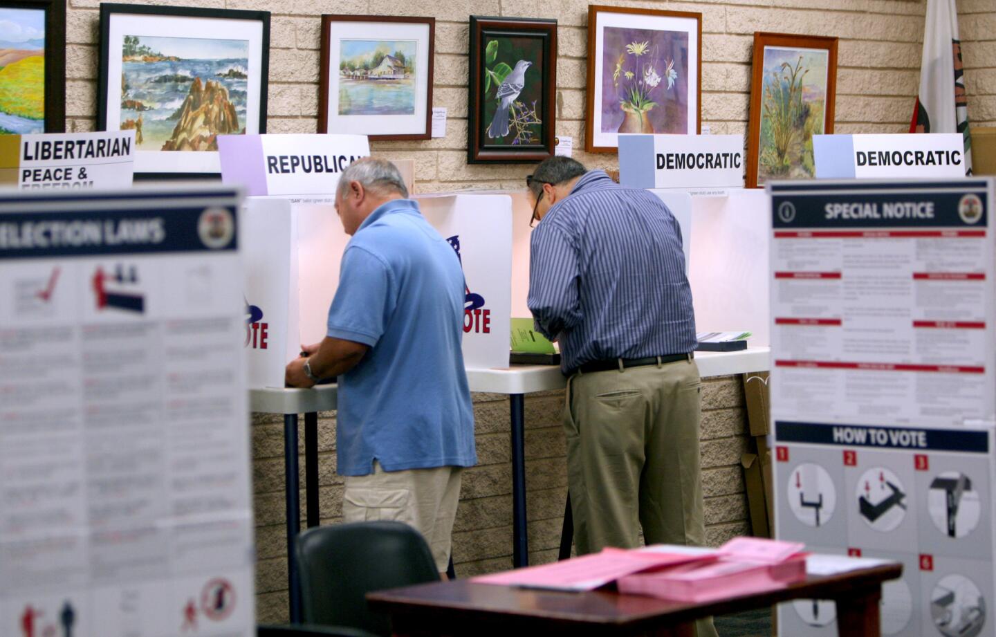 With walls full of colorful art, voters cast their ballots at the La Cañada Flintridge Library, in La Cañada Flintridge on Tuesday, June 7, 2016.