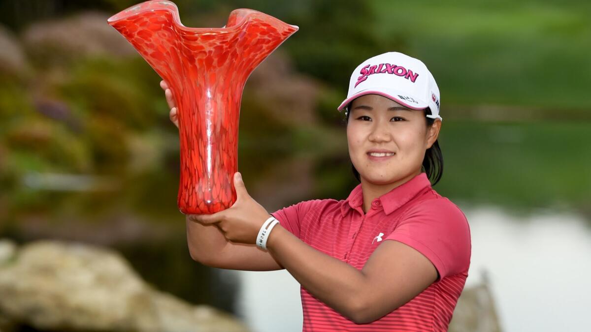 Nasa Hataoka poses with the trophy after winning the Kia Classic at Aviara Golf Club on Sunday.