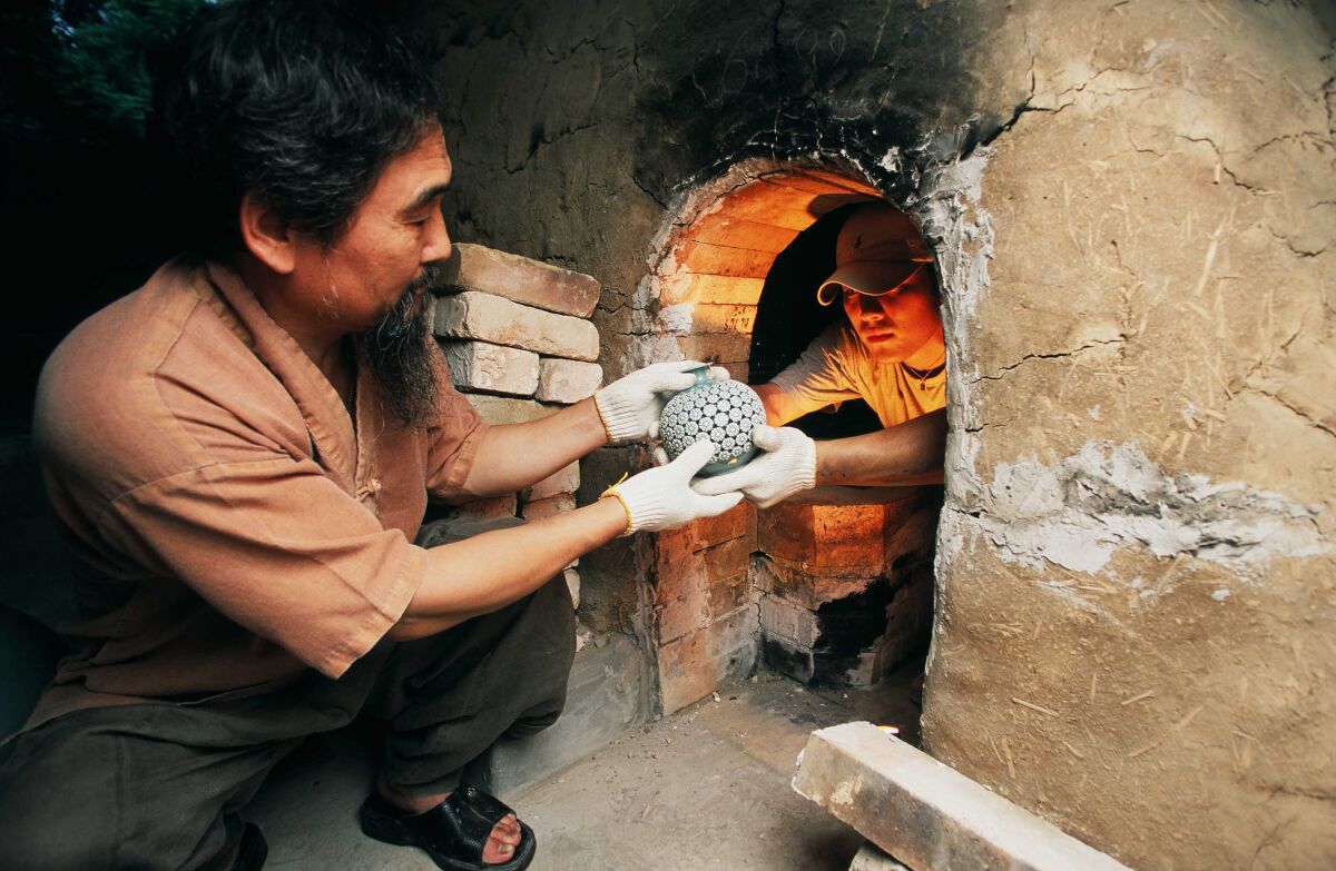 Master Kim Se-Yong and his son, Dohun Kim, work together to fire Korean Goryeo Celadon ceramics.