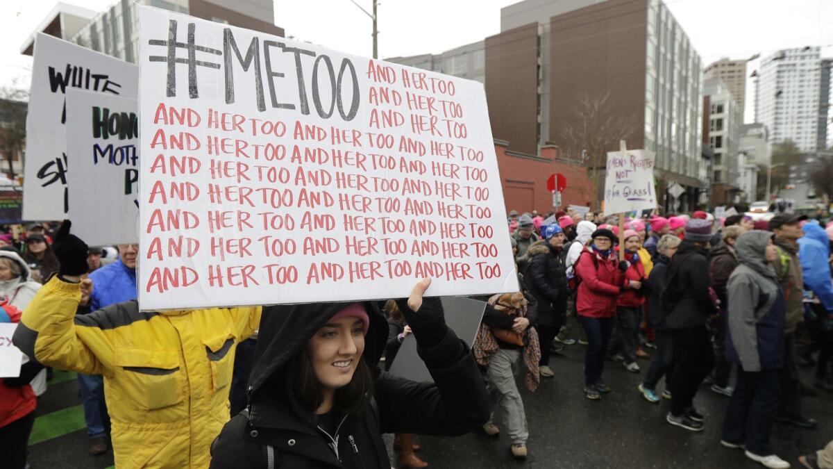 A demonstrator carries a #MeToo sign at a women's march in Seattle in January.