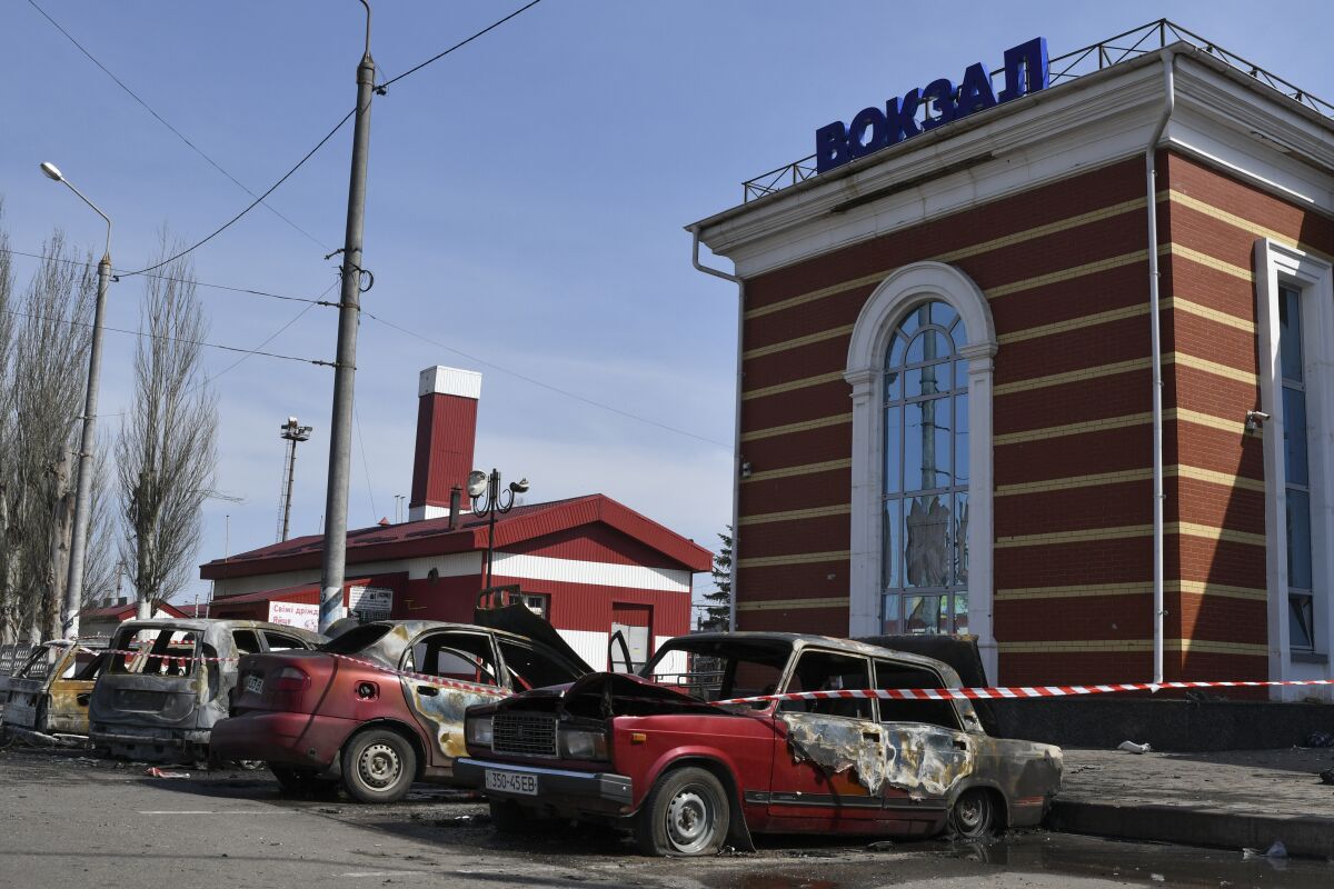 FILE - Damaged cars in front of the railway station after Russian shelling in Kramatorsk, Ukraine, April 8, 2022. Russia's military on Wednesday May 4 2022, launched a string of attacks on Ukraine's railway network, which has been vital for moving Western arms to Ukrainian forces, evacuating refugees and exporting food. The largely flat country has a vast railway network, which has proved invaluable from a military viewpoint for supplying key Western arms shipments — and has also helped in the exodus of refugees from Russian air assaults and land advances. (AP Photo/Andriy Andriyenko, File)