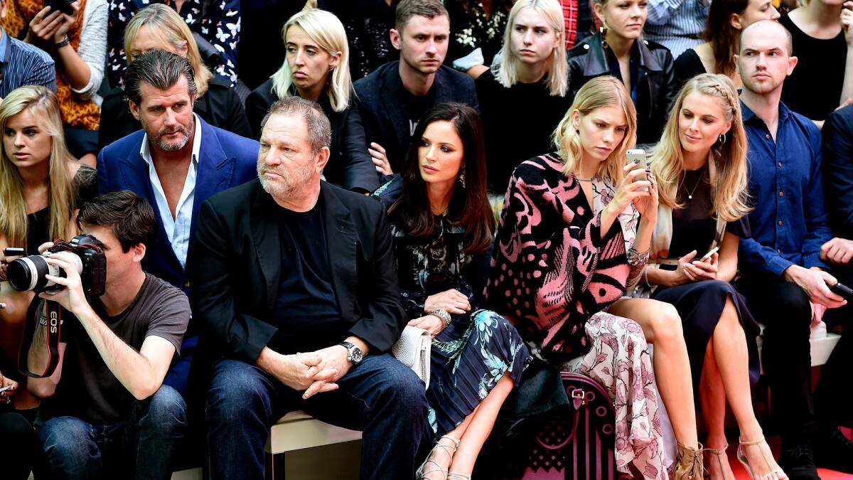 From left, Harvey Weinstein, his wife Georgina Chapman, Elena Perminova and Donna Air attend a Burberry fashion show during London Fashion Week in 2014.