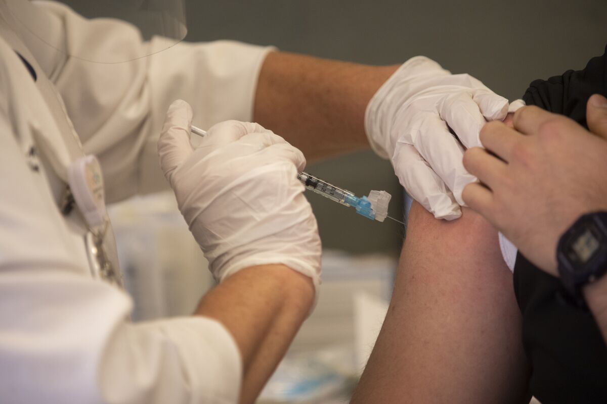 An RN gives the the SARS-CoV-2 vaccination in Los Angeles, CA. 