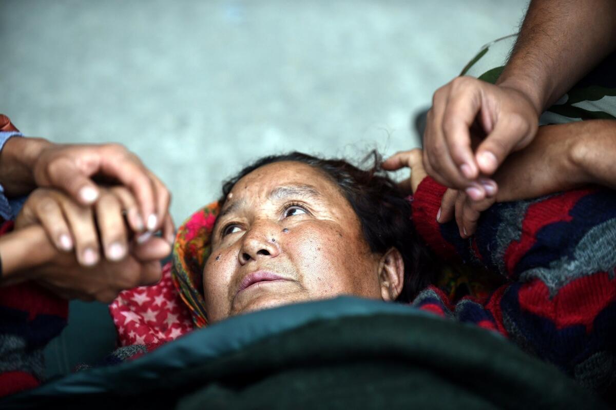 An injured Nepalese woman at a field hospital at a Katmandu airport April 29.