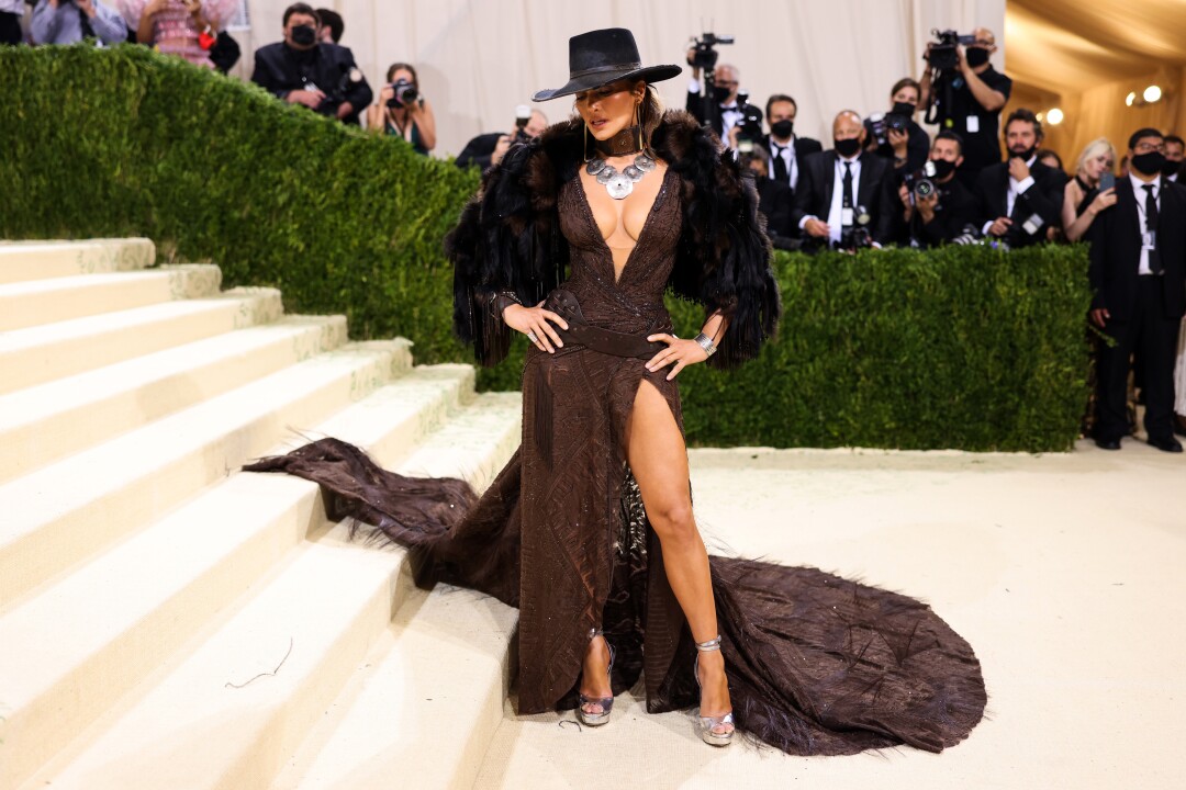 A woman in a cowboy hat and a low-cut dress.