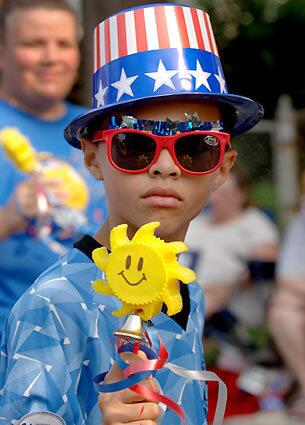 Picnickers and party-goers celebrate Independence Day from coast to coast. Taki Burroughs participates in a parade in Dundalk, Md.