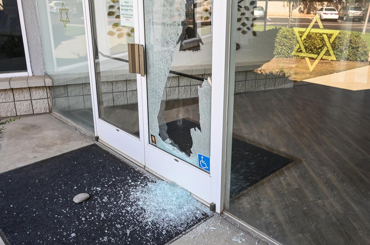 Broken glass and a nearby rock are shown on the doors of Temple Beth Israel, in Fresno.