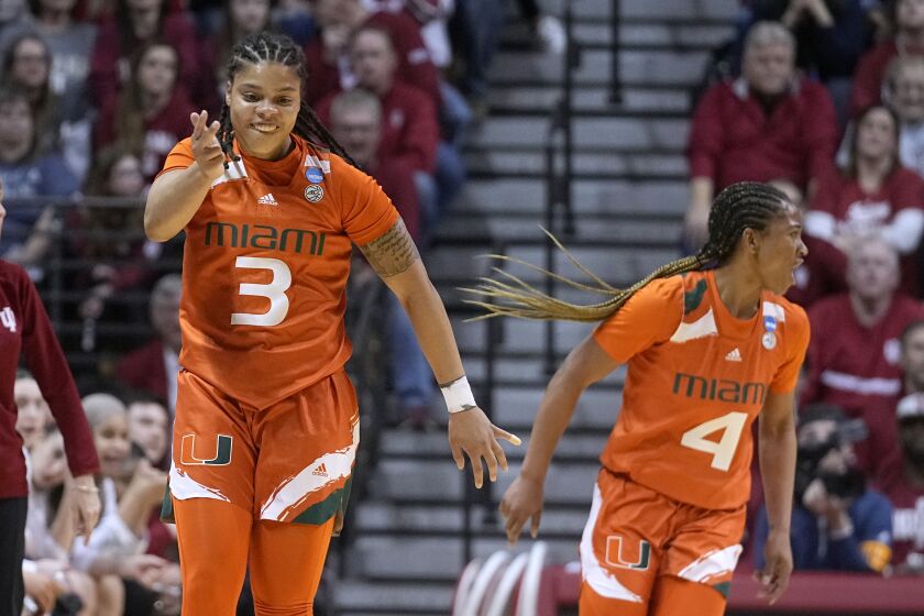 Miami's Destiny Harden (3) celebrates along with teammate Jasmyne Roberts (4) during the first half of a second-round college basketball game against Indiana in the women's NCAA Tournament Monday, March 20, 2023, in Bloomington, Ind. (AP Photo/Darron Cummings)
