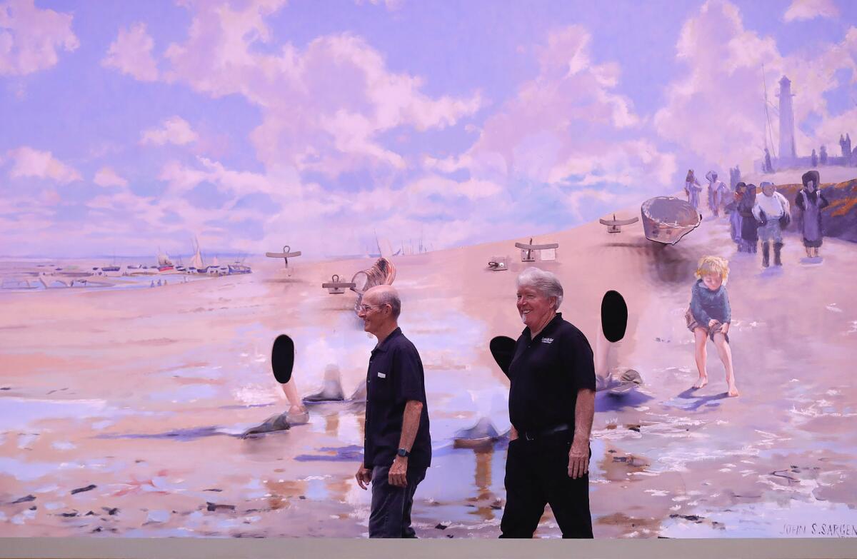 Butch Hill, technical director, and Dan Duling, script writer stand in front of "Oyster Gatherers" by John Singer Sergeant.