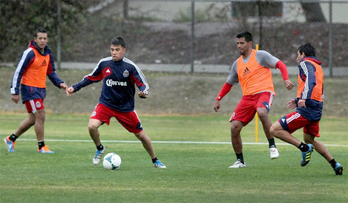 Carlos Suarez, second from left, practices with members of Chivas USA in January 2013. Major League Soccer is taking over the troubled franchise.