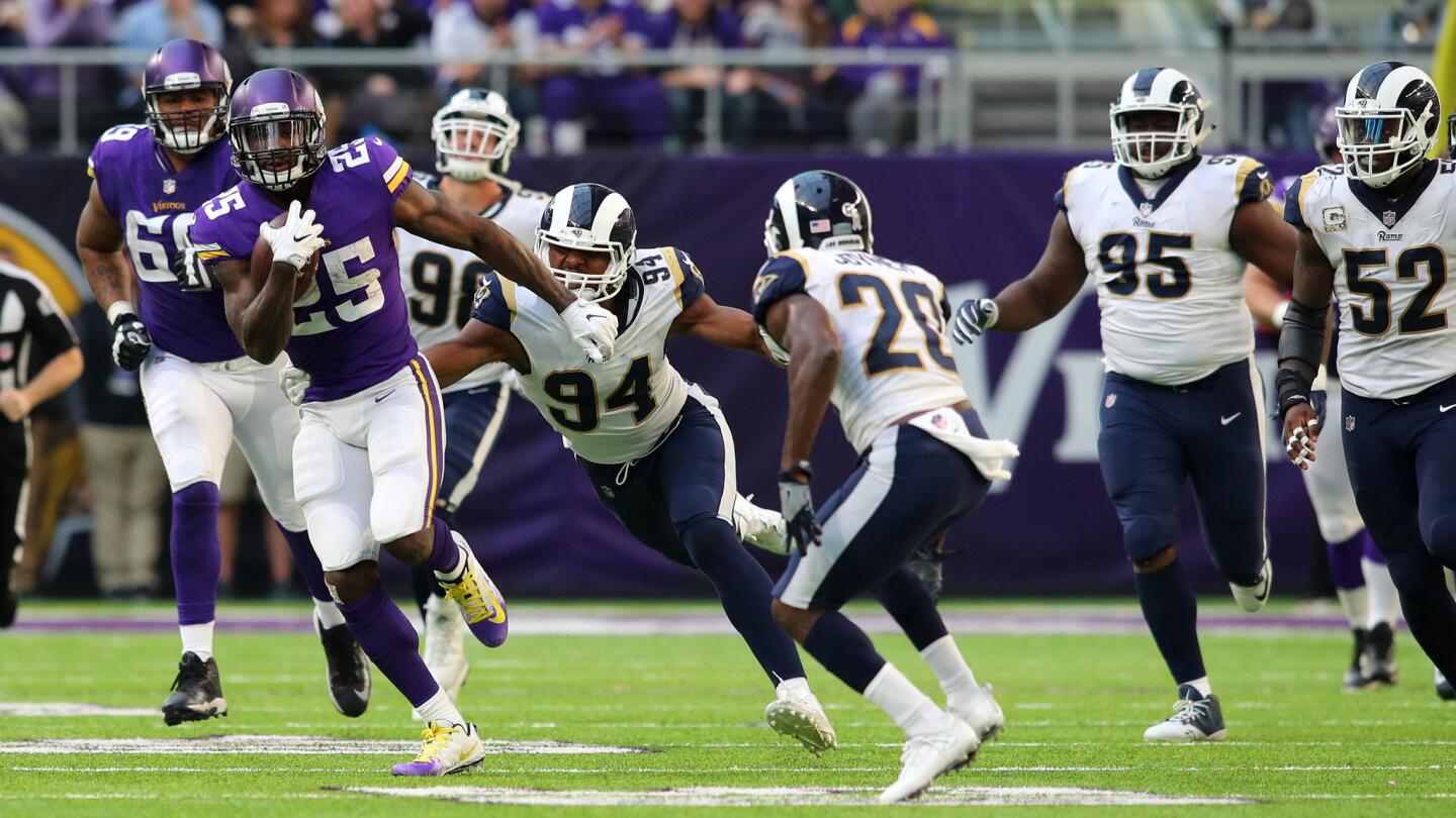 Vikings' Latavius Murray is pursued by the Rams defense in second half action.