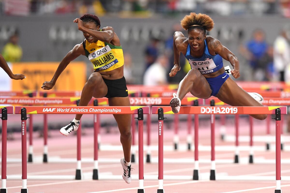 Nia Ali, right, competes in the women's 100-meter hurdles at the IAAF World Athletics Championships on Sunday.