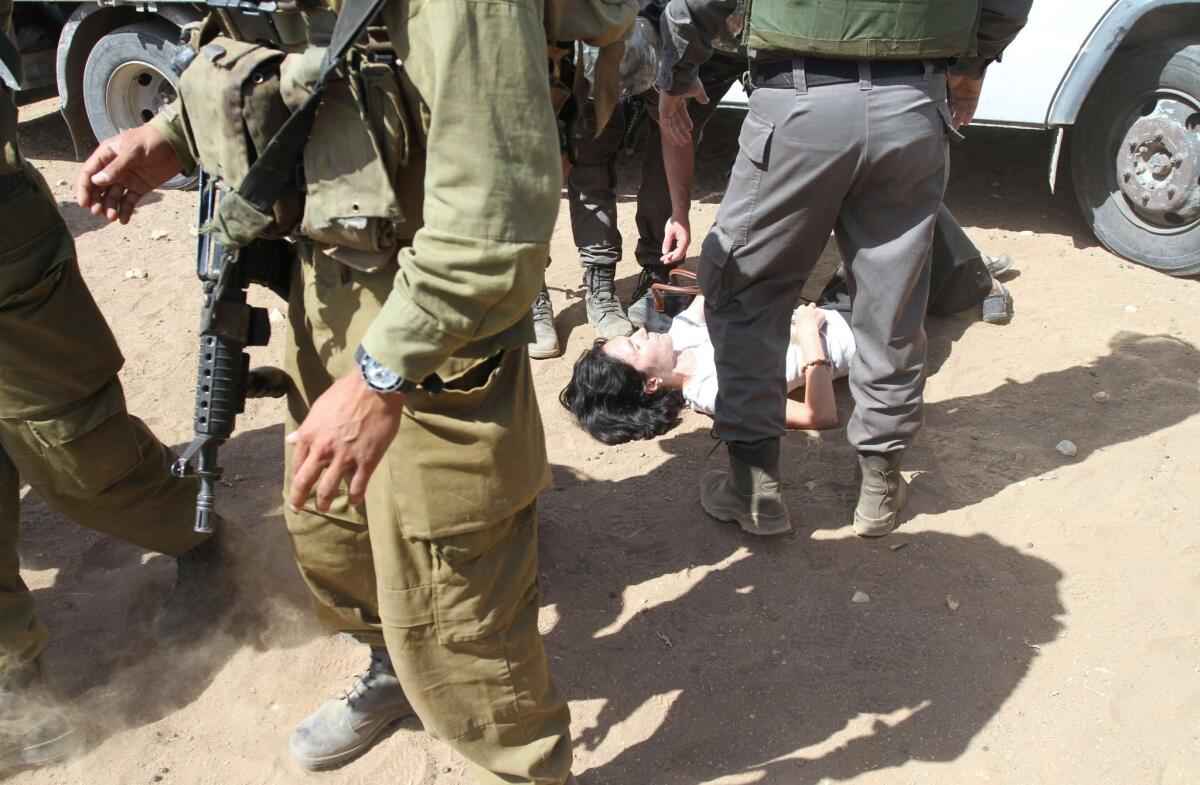 French diplomat Marion Fesneau-Castaing lies on the ground amid Israeli soldiers on the road leading to the West Bank village of Khirbet Makhoul.