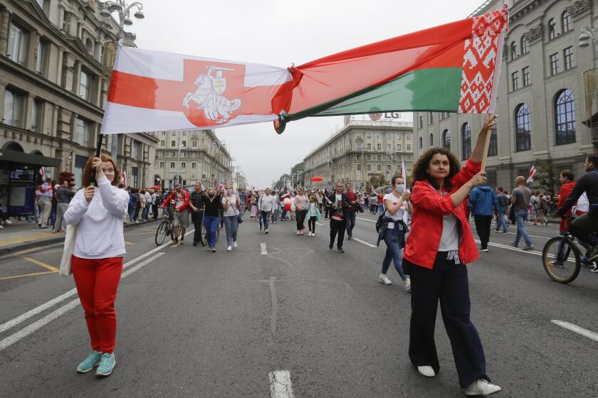 Demonstrators fill the streets of Minsk, Belarus, Sunday, Aug. 23, 2020. Demonstrators are taking to the streets of the Belarusian capital and other cities, keeping up their push for the resignation of the nation's authoritarian leader, president Alexander Lukashenko, in a massive outburst of dissent that has shaken the country since dubious presidential elections two weeks ago.(AP Photo/Sergei Grits)