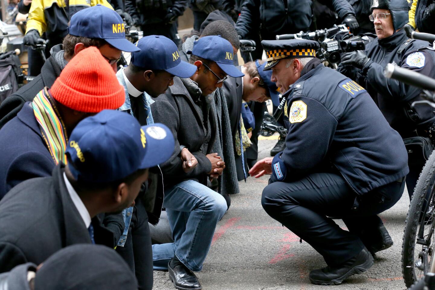 An officer talks Nov. 30, 2015 to NAACP chief Cornell William Brooks as a protest over Laquan McDonald's killing blocks LaSalle Street by City Hall.
