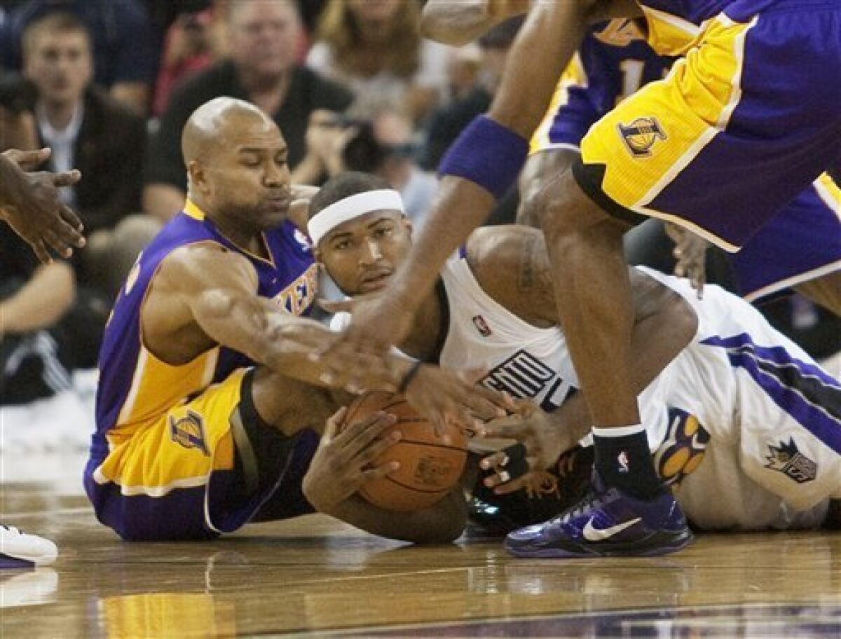 Los Angeles Lakers' Derek Fisher (2), left and the Sacramento Kings' DeMarcus Cousins (15) right, battle for the ball in the first half in Sacramento, Calif., Wednesday Nov. 3, 2010. (AP Photo/Robert Durell)