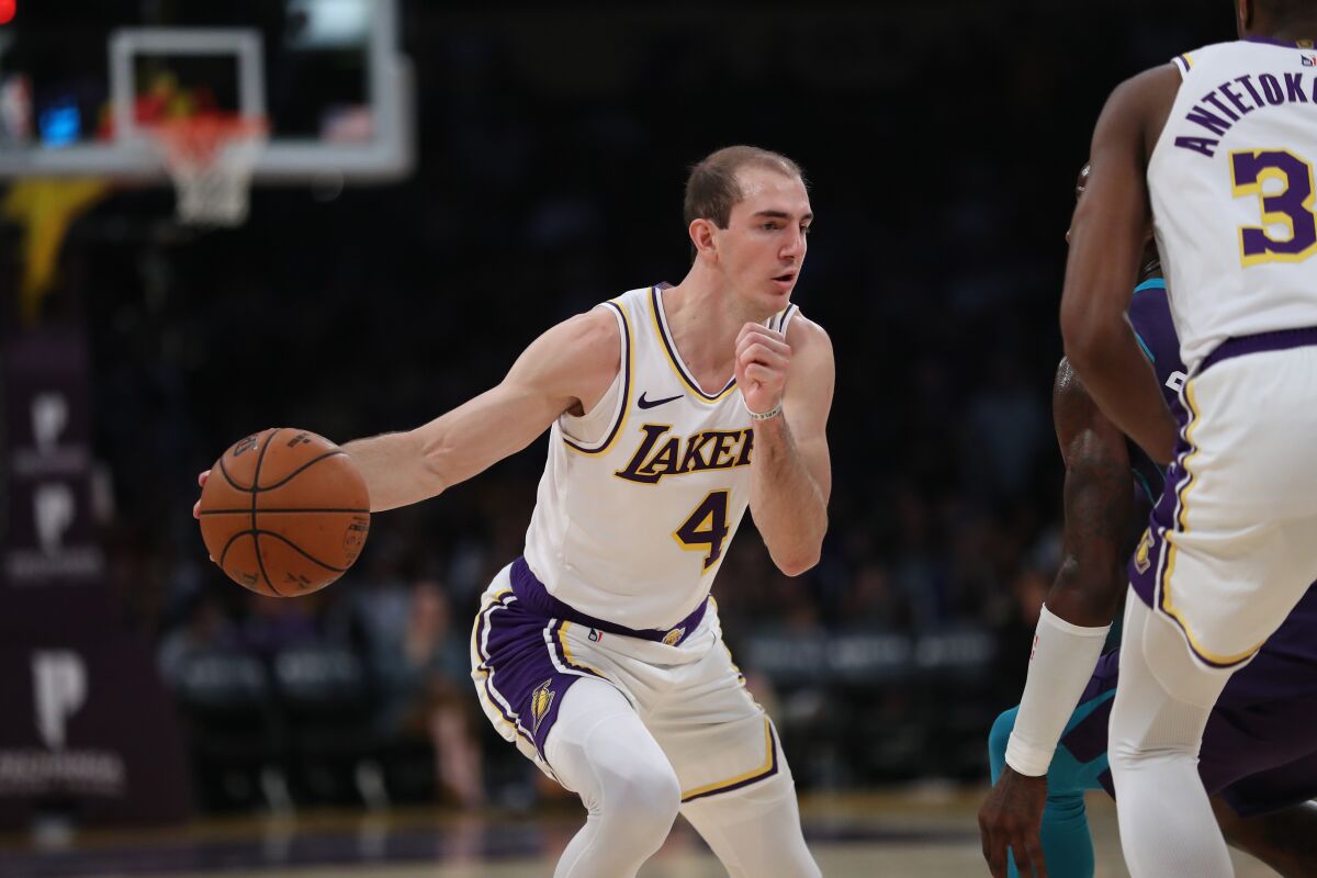 Lakers guard Alex Caruso drives to the basket during a win over the Charlotte Hornets on Sunday.