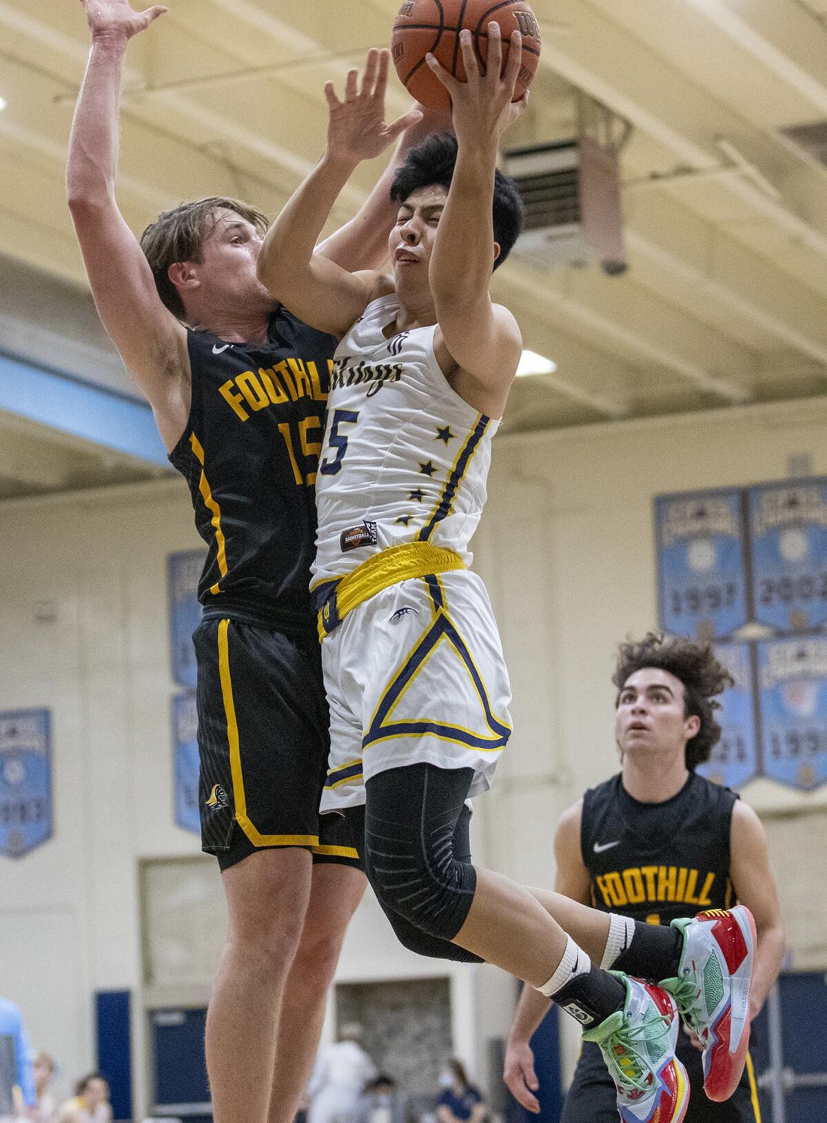 Marina's Kenji Duremdes goes up for a shot against Foothill's Braedyn Benhard during a CIF Division 2AA playoff game.