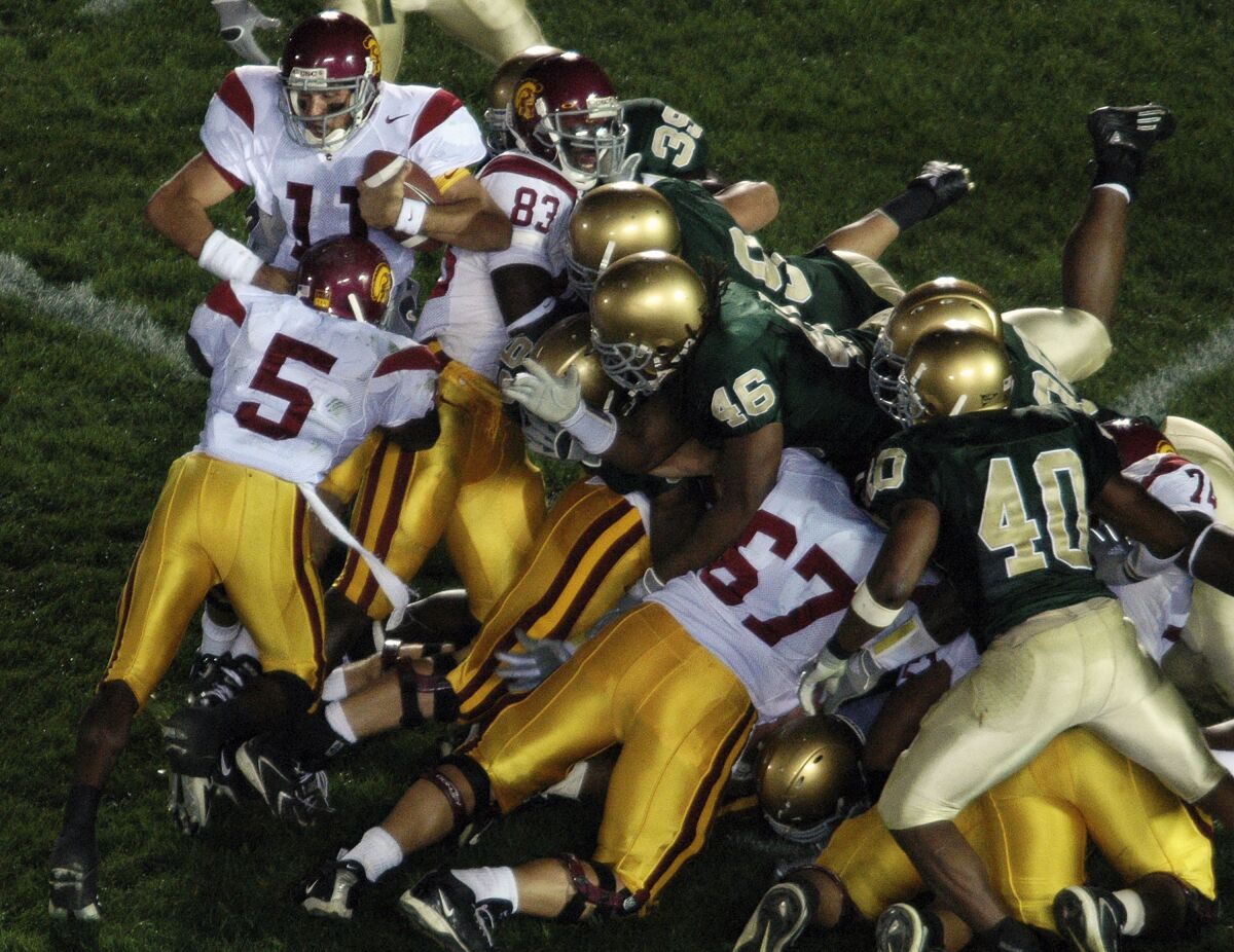 USC's Reggie Bush (5) pushes  Matt Leinhart (11) into the end zone for a victory over Notre Dame on Oct. 15 2005.