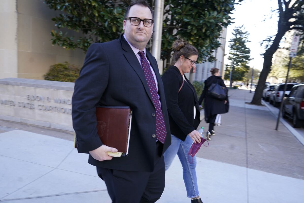 Former Los Angeles Angels employee Eric Kay, left, walks out of federal court  in Fort Worth, Texas