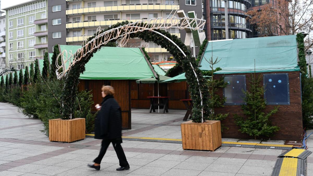 A woman walks past the entrance of the Christmas market in Ludwigshafen, Germany, on Friday.