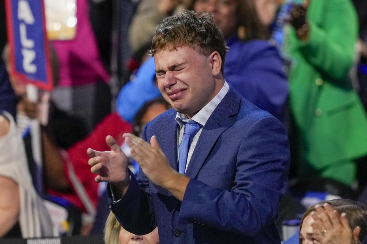 Gus Walz cries as his father, Minnesota Gov. Tim Walz, speaks during the Democratic National Convention.