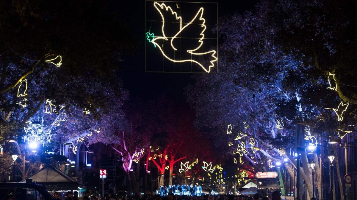 An illuminated peace dove hovers above Barcelona's Las Ramblas in 2017. Post-holiday fares are as low as $396 round trip in parts of January and February.