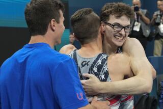 Stephen Nedoroscik, of U.S., gets a hug from Paul Juda after he completed his pommel horse routine 