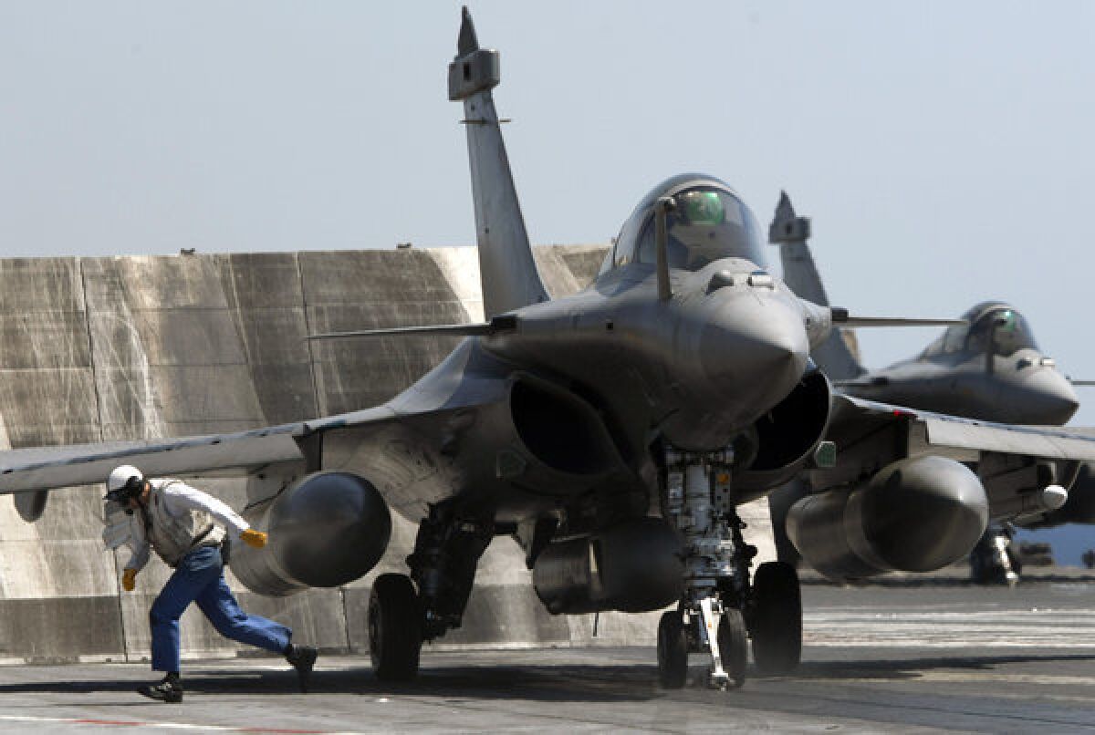 A French Rafale fighter jet, of the type available to fly sorties in support of U.S.-led strikes against Syria, sits aboard the aircraft carrier Charles de Gaulle.