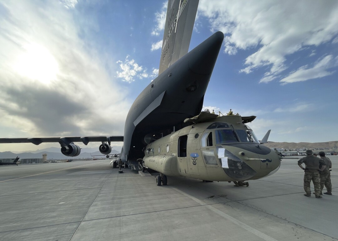 A CH-47 Chinook from the 82nd Combat Aviation Brigade, 82nd Airborne Division is loaded onto a U.S. Air Force C-17