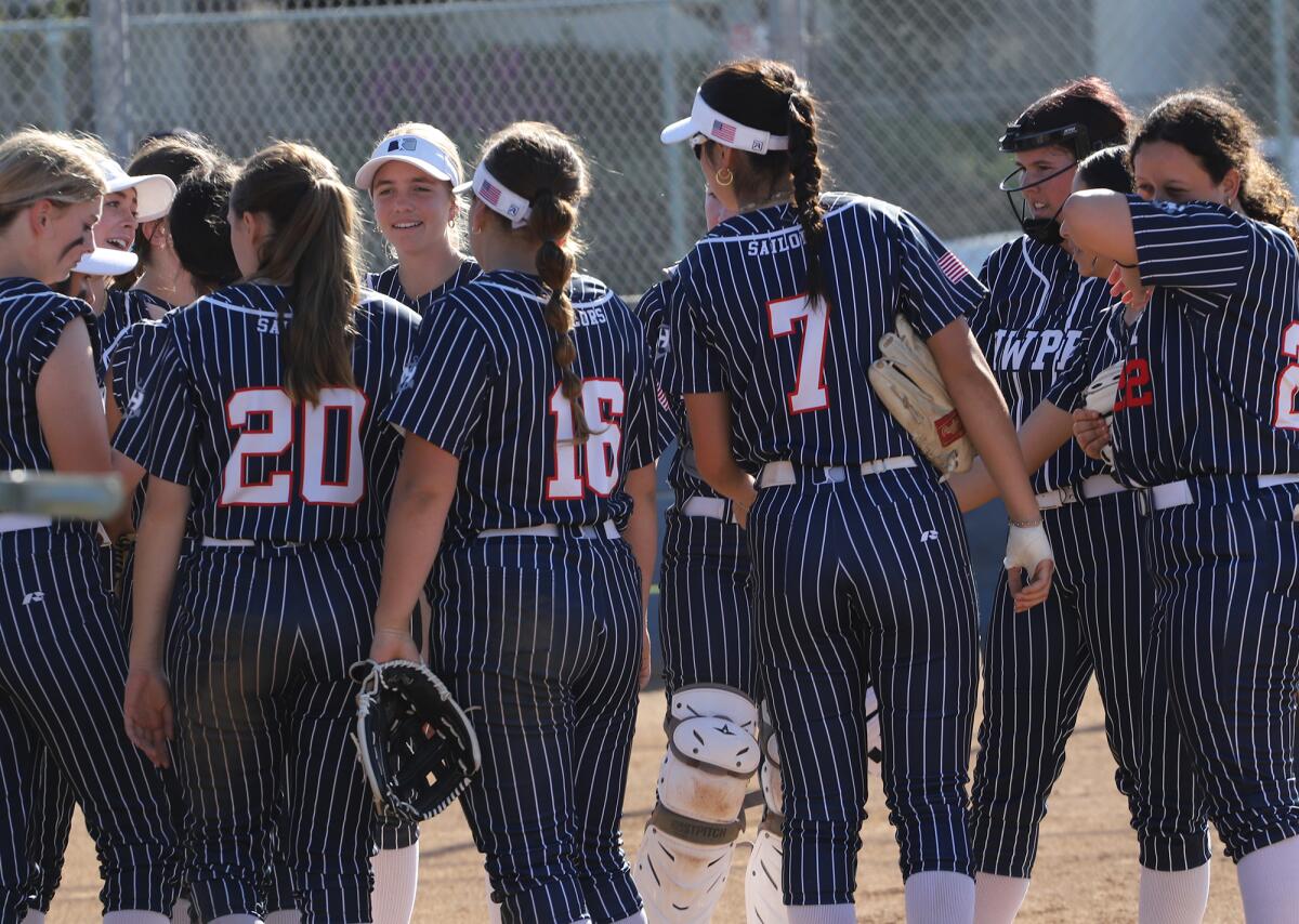 Newport Harbor's softball team is all smiles after scoring against Corona del Mar on Tuesday.