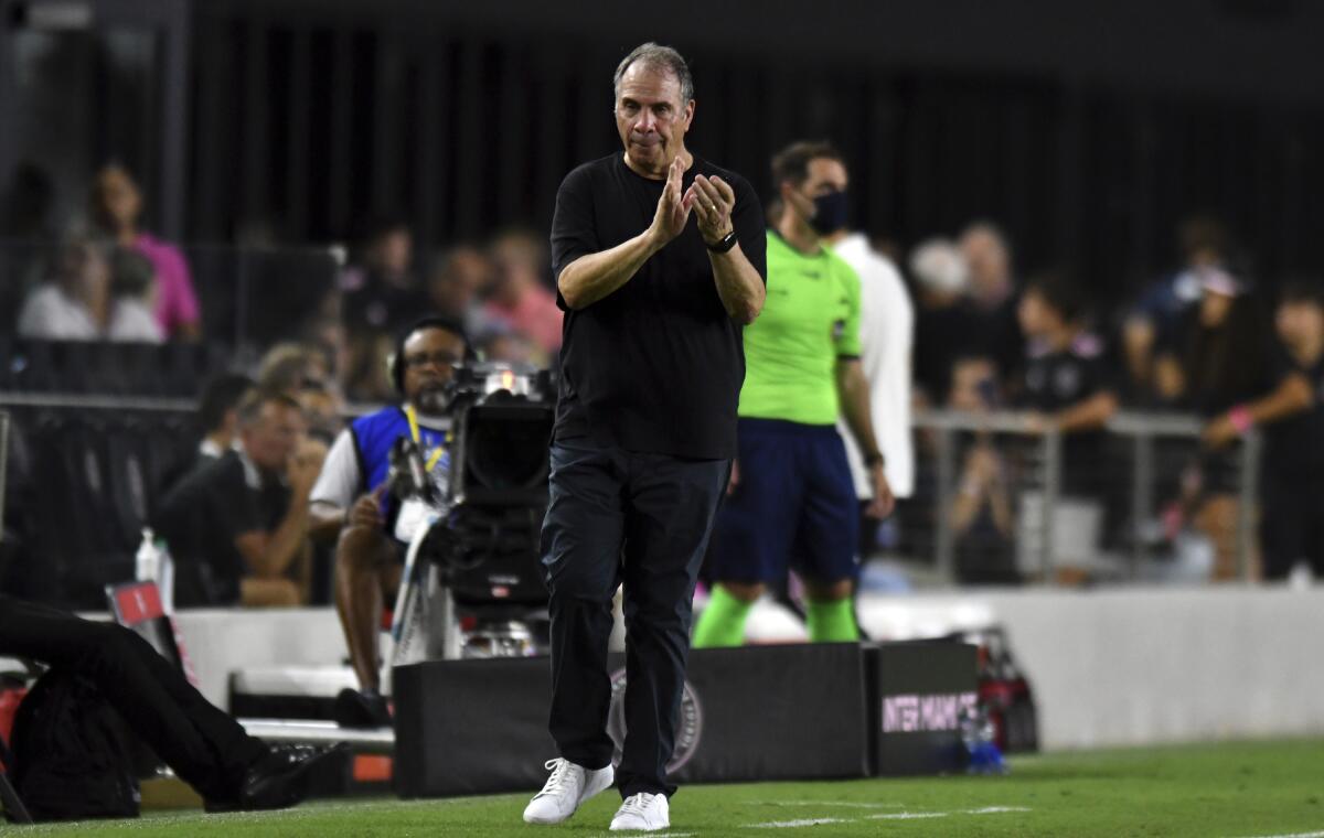 New England Revolution head coach Bruce Arena applauds his team during a match against Inter Miami 