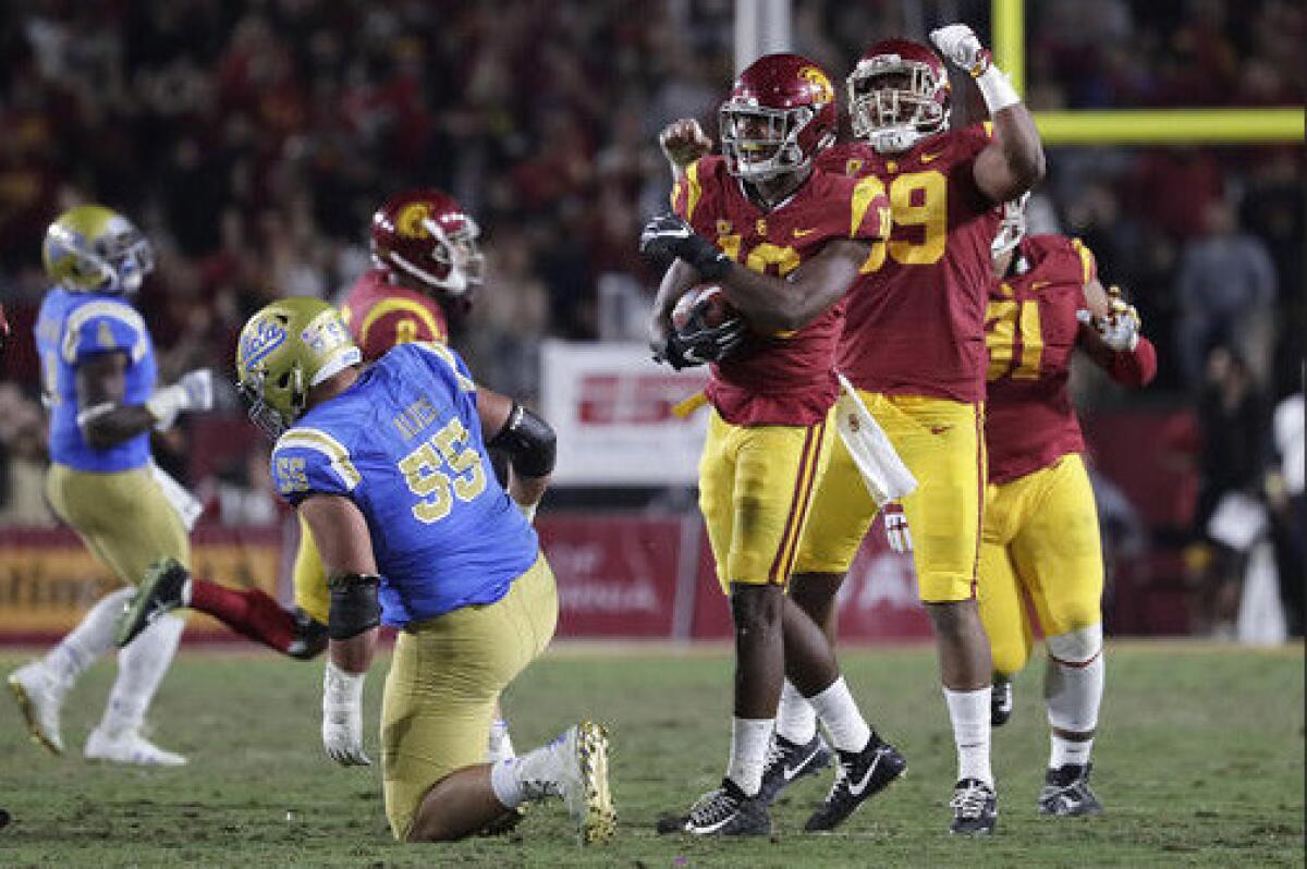 USC linebacker John Houston Jr. celebrates after scooping up a Josh Rosen fumble during second quarter action at the Coliseum.