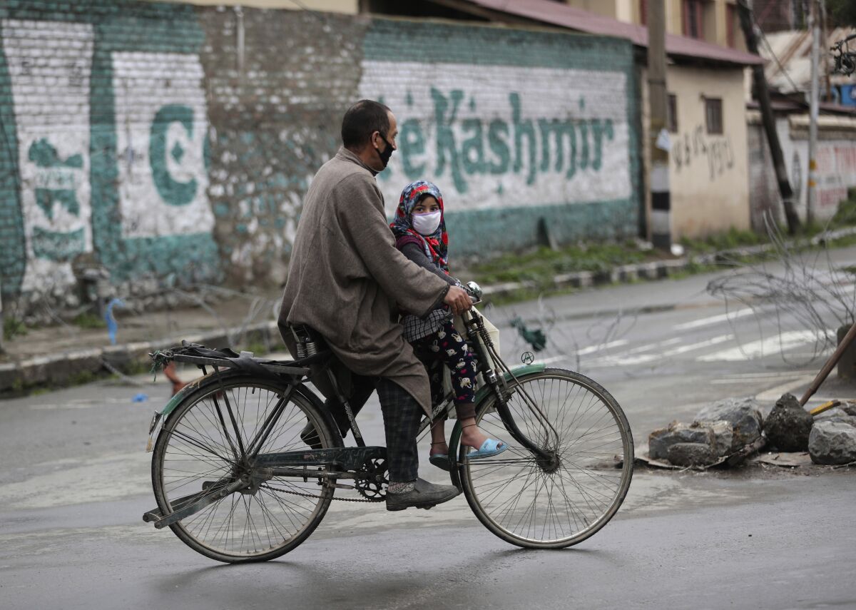 A Kashmiri man rides his bicycle