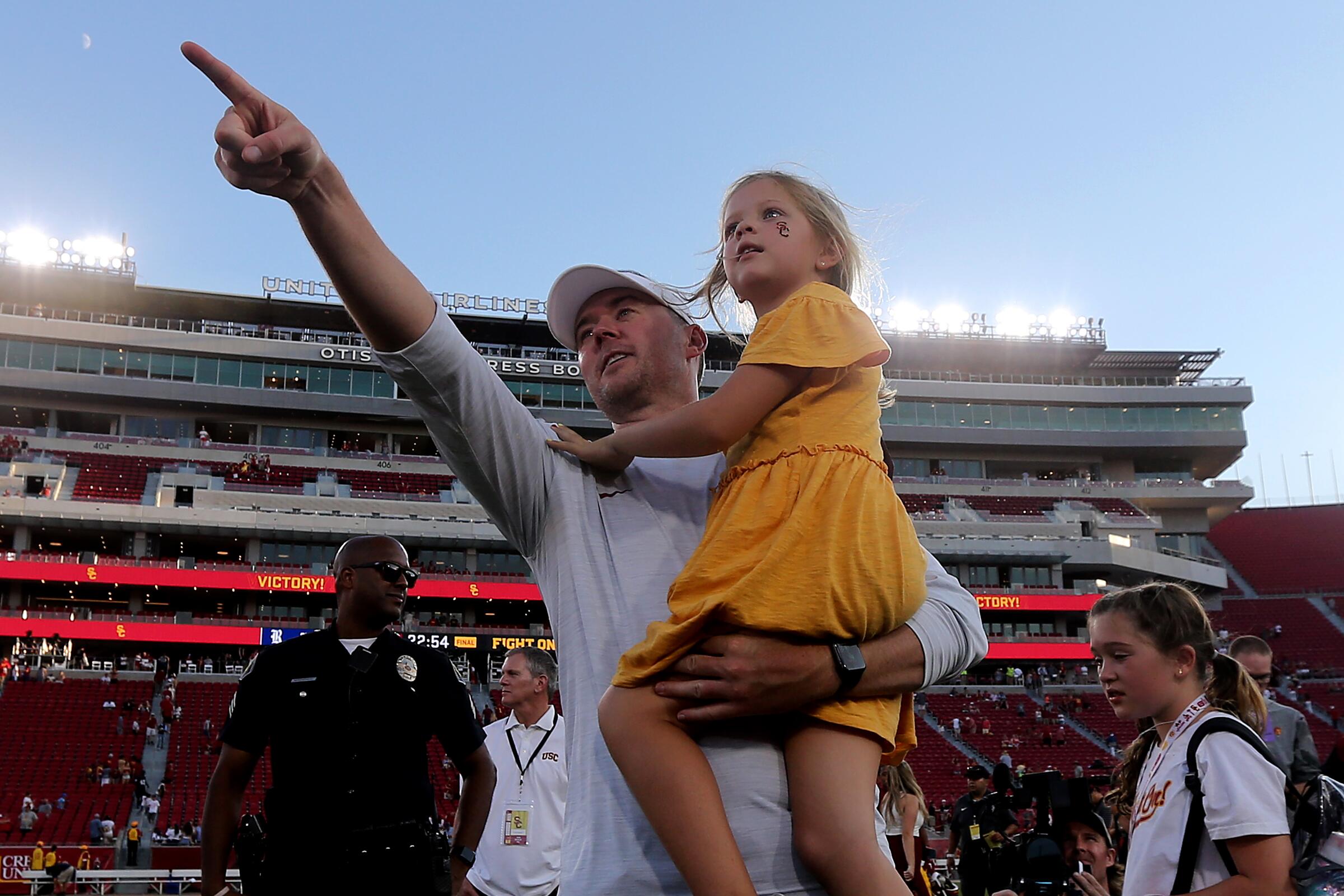 USC coach Lincoln Riley celebrates with his daughter after the Trojans' 66-14 victory over Rice.