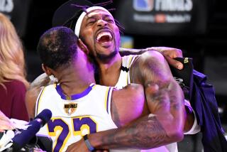 Dwight Howard closes his eyes as he embraces LeBron James as they celebrate after the Lakers' 2020 NBA championship.