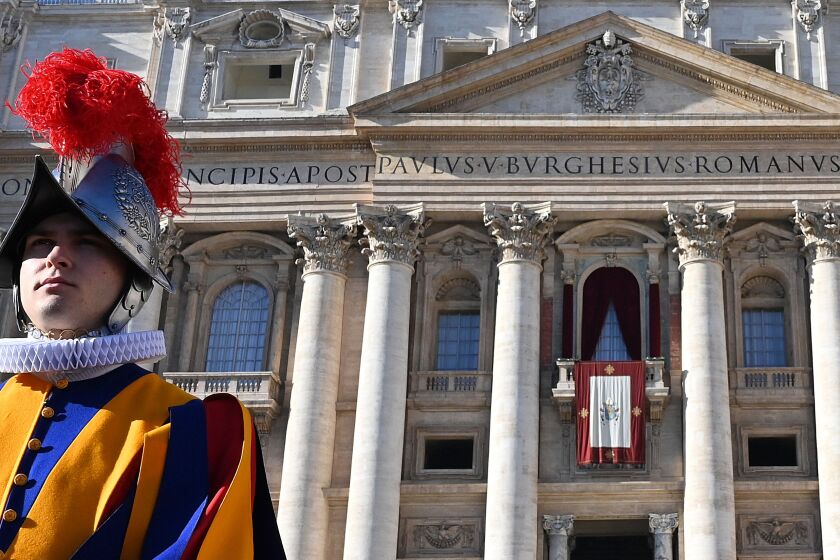 A Swiss guard stands in front of St Peter's Basilica before the appearance of Pope Francis at the balcony for the traditional "Urbi et Orbi" Christmas message to the city and the world, at St Peter's square in Vatican, on December 25, 2019. (Photo by Alberto PIZZOLI / AFP) (Photo by ALBERTO PIZZOLI/AFP via Getty Images)