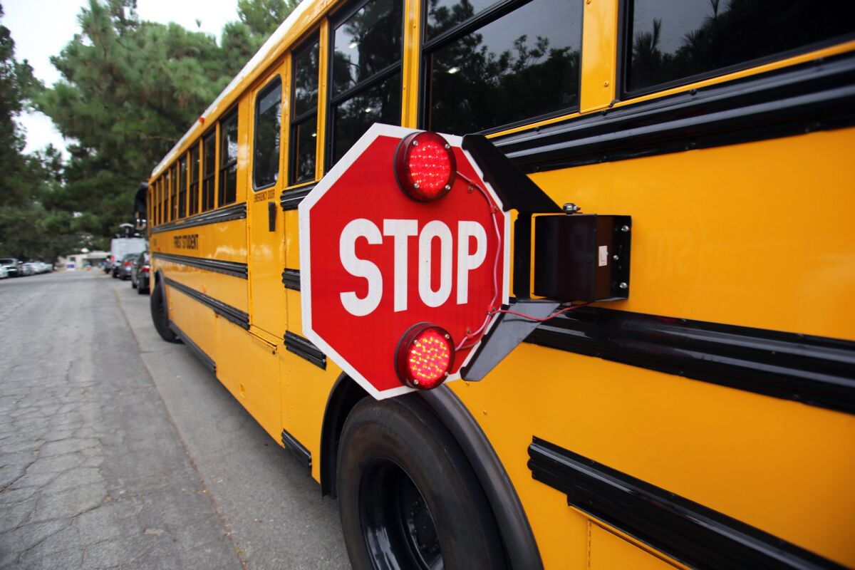 The First Student school bus has a more visible stop sign and red lights to alert drivers.