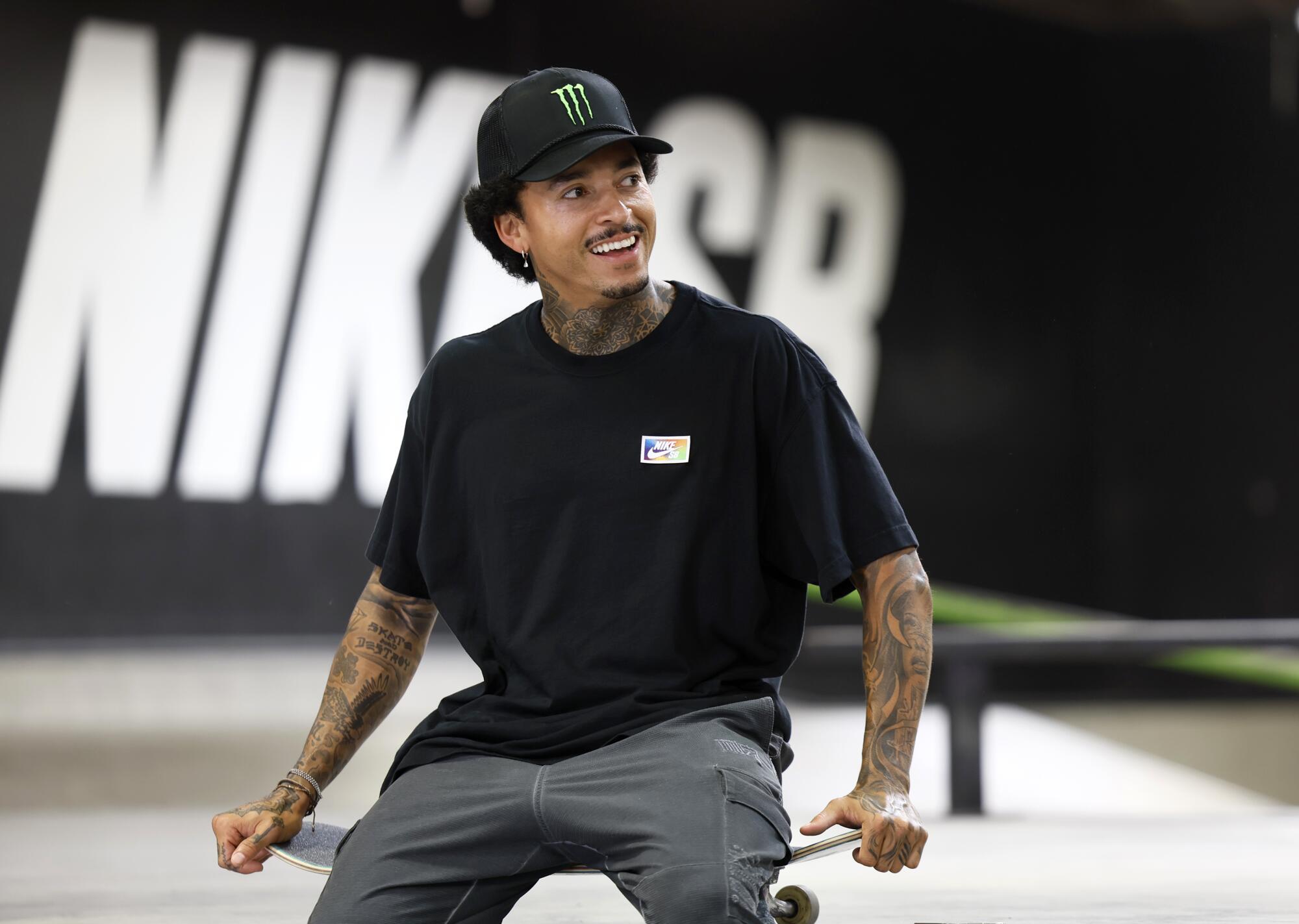 Nyjah Huston smiles while talking to friends during training in San Clemente.