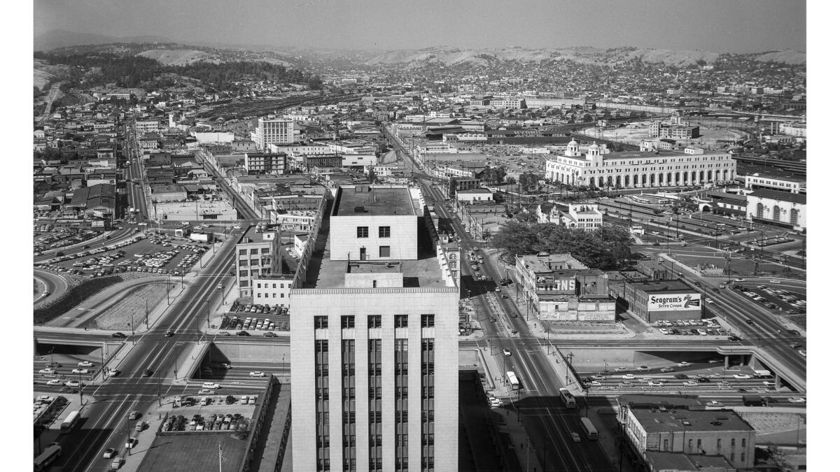 June 3, 1956: There were a million landmarks to tell you that the camera was pointed north from the City Hall tower. In the foreground are the top of the Federal Building and the Hollywood-Santa Ana Freeway. Off to the right are the clump of trees that is the Plaza and beyond it the Post Office Terminal Annex. At the extreme left N Broadway heads toward the tree-covered hills of Elysian Park.