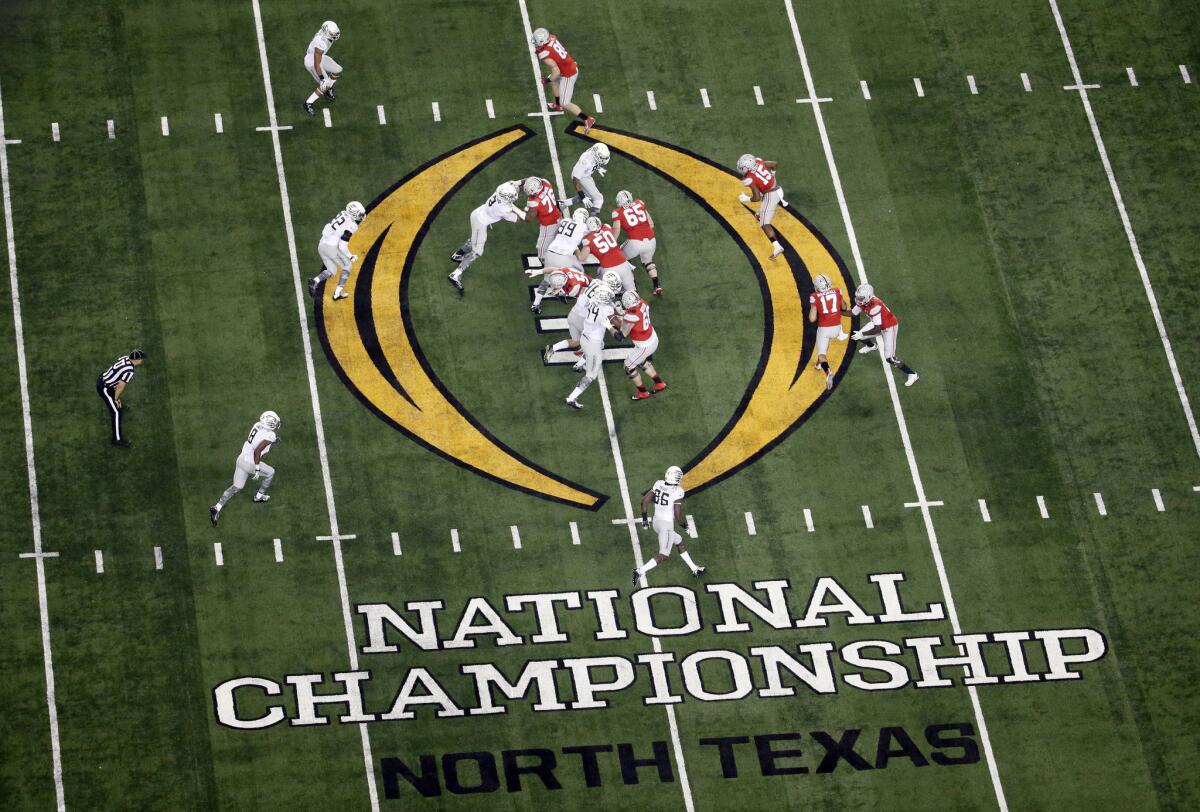 Ohio State, right, and Oregon play during the first half of the NCAA College Football Playoff national championship game in Arlington, Texas.