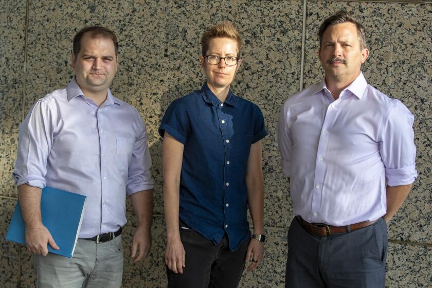 CHATSWORTH, CALIF. -- TUESDAY, SEPTEMBER 24, 2019: Former students of now-defunct for-profit college Video Symphony, Andrew Carslaw, left, Sheri Wheeler, center, and Michael Peck, right, outside Los Angeles Superior Court in Chatsworth, Calif., on Sept. 24, 2019. (Brian van der Brug / Los Angeles Times)