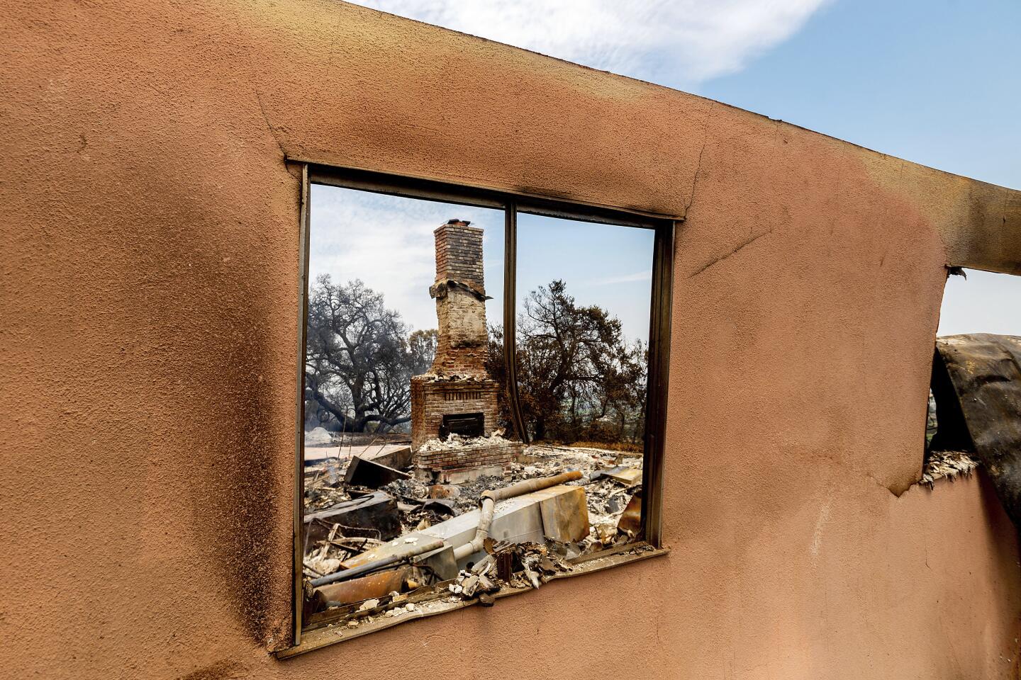 A chimney stands amid the rubble of a home destroyed in the River fire.