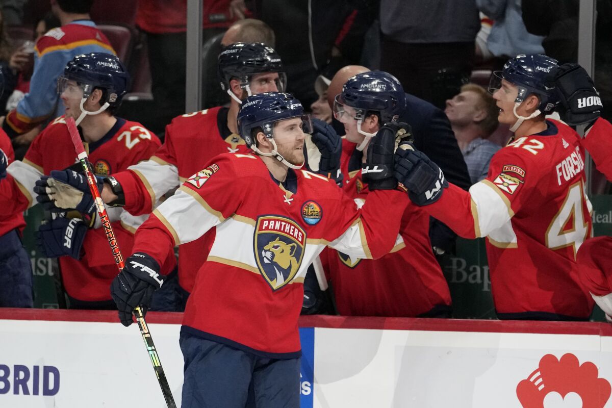 Florida Panthers center Chris Tierney (71) is congratulated for his goal against the Detroit Red Wings during the first period of an NHL hockey game Thursday, Dec. 8, 2022, in Sunrise, Fla. (AP Photo/Lynne Sladky)