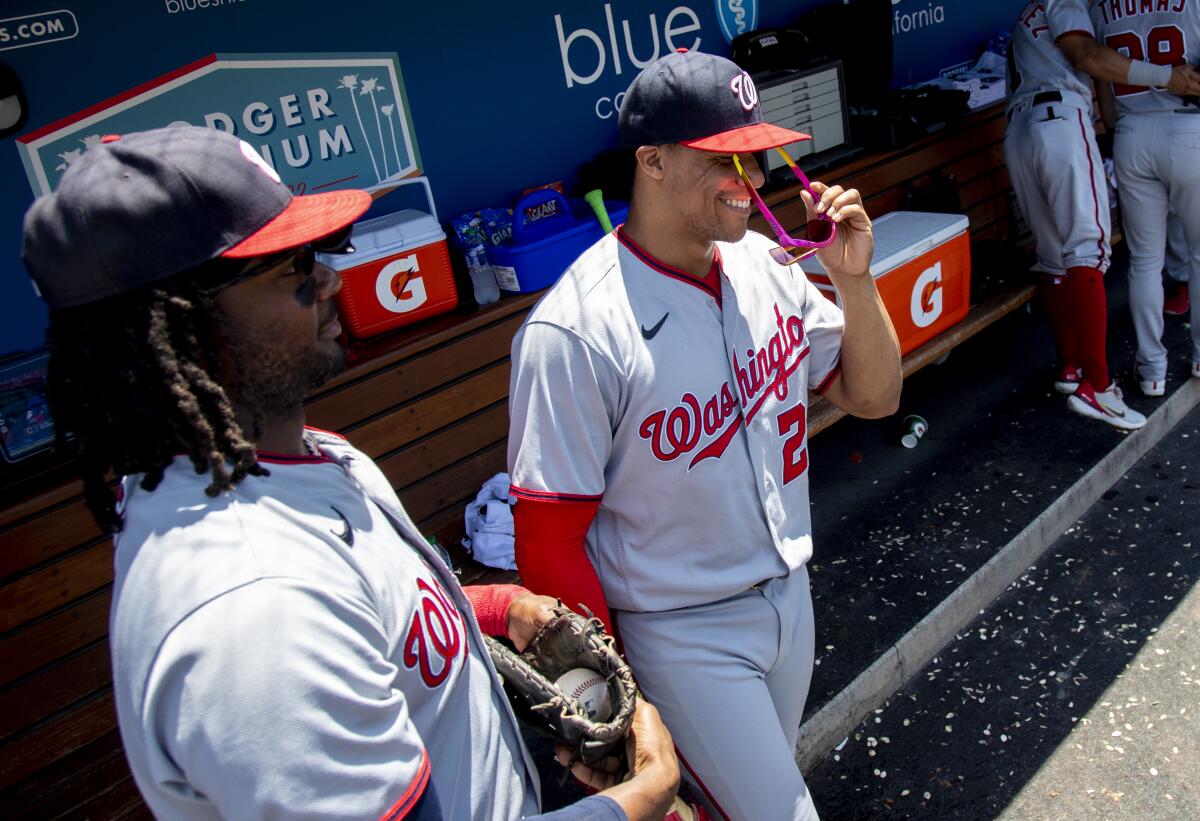 Washington Nationals right fielder Juan Soto puts on his sunglasses before heading out to the field.