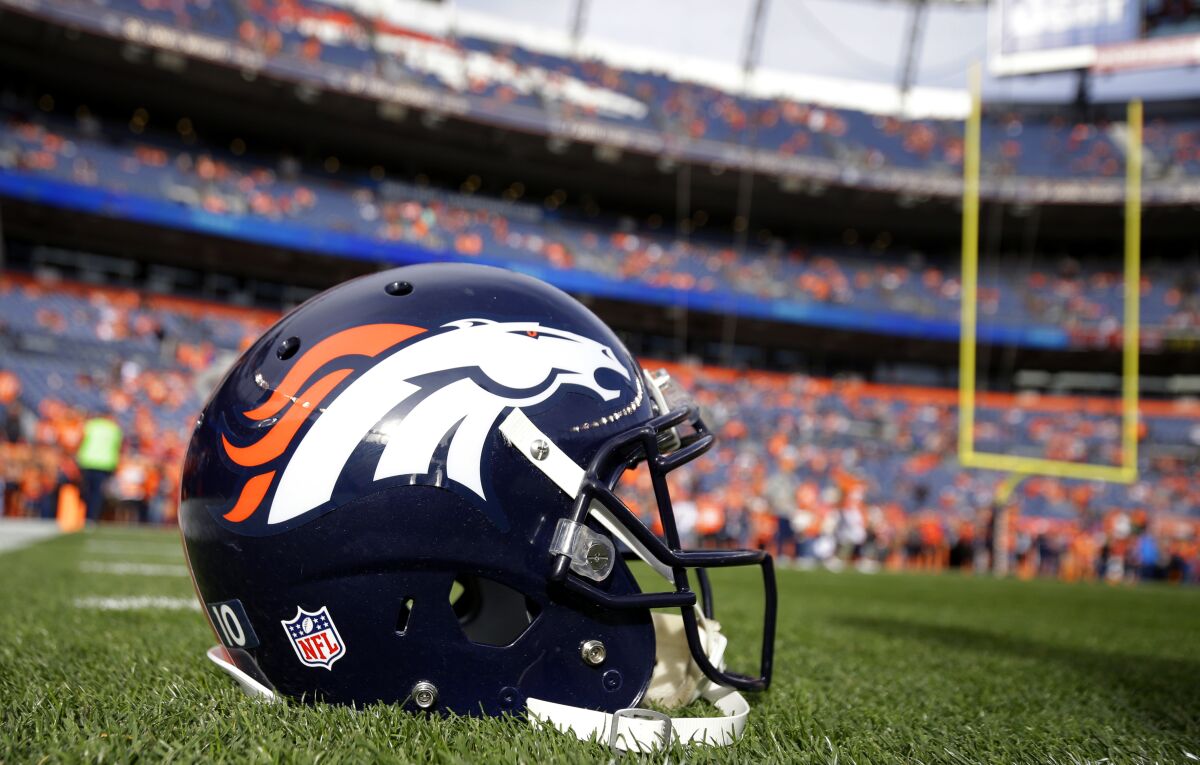 FILE - A Denver Broncos helmet sits on the field prior to an NFL football game between the Denver Broncos and the Cincinnati Bengals, Sunday, Nov. 19, 2017, in Denver. The Denver Broncos are looking for a new owner in what’s expected to be the most expensive team sale in U.S. sports history. The Pat D. Bowlen Trust announced Tuesday, Feb. 1, 2022, it's in the “beginning of a sale process” for the franchise that's valued at $4 billion and is expected to draw heavy bidding that could push the sale price well beyond that figure.(AP Photo/Jack Dempsey, File)