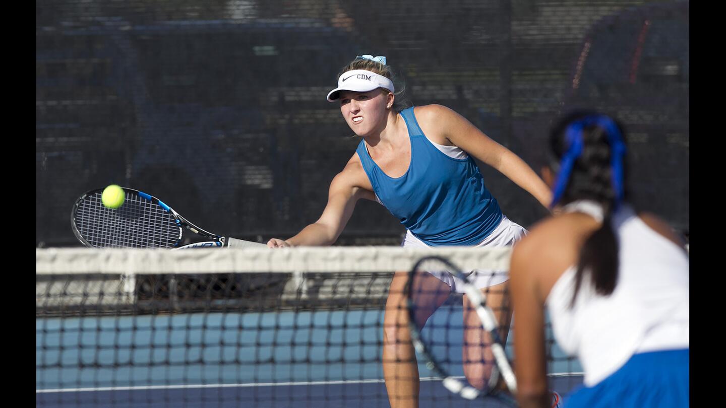 CDM doubles player Shaya Northrup reaches for a winning volley with partner Paulina Loredo in quarterfinal tennis action against San Marino on Monday.