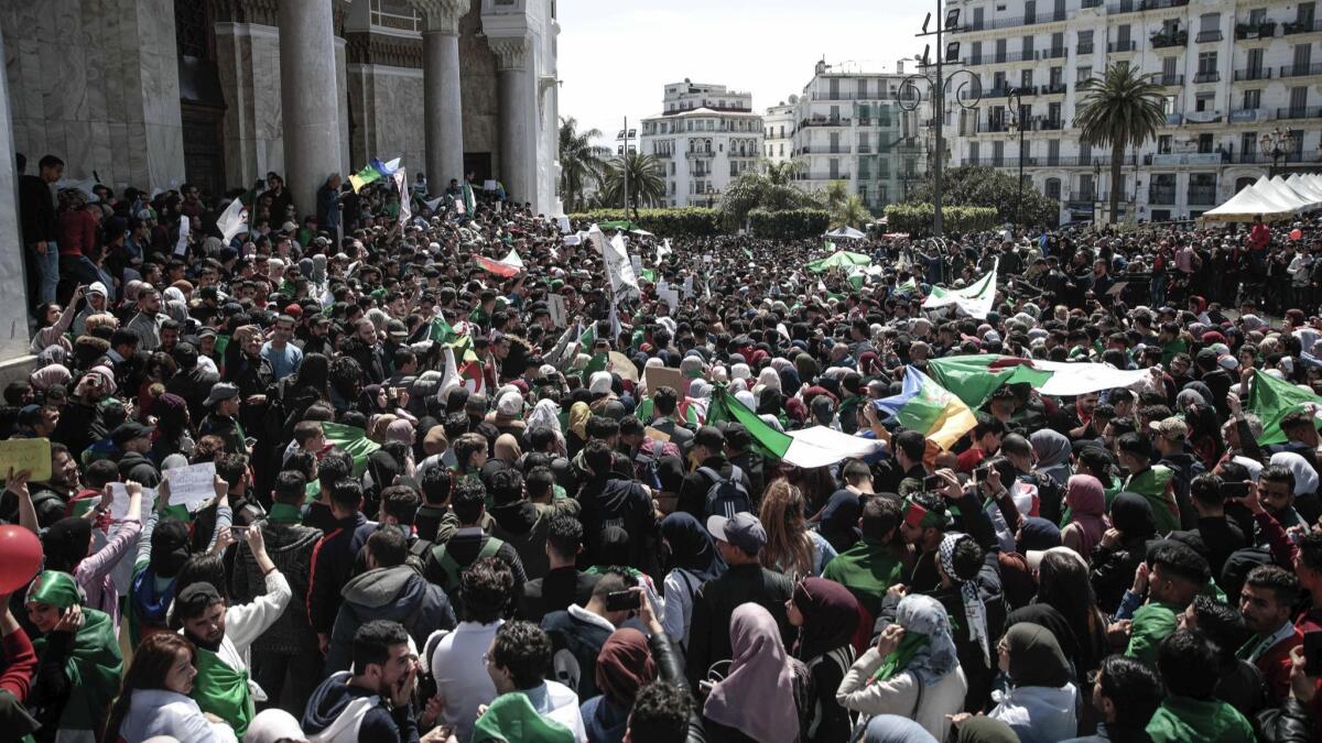 Algerian students wave flags and chant slogans during a demonstration in Algiers, the capital, on April 9, 2019.