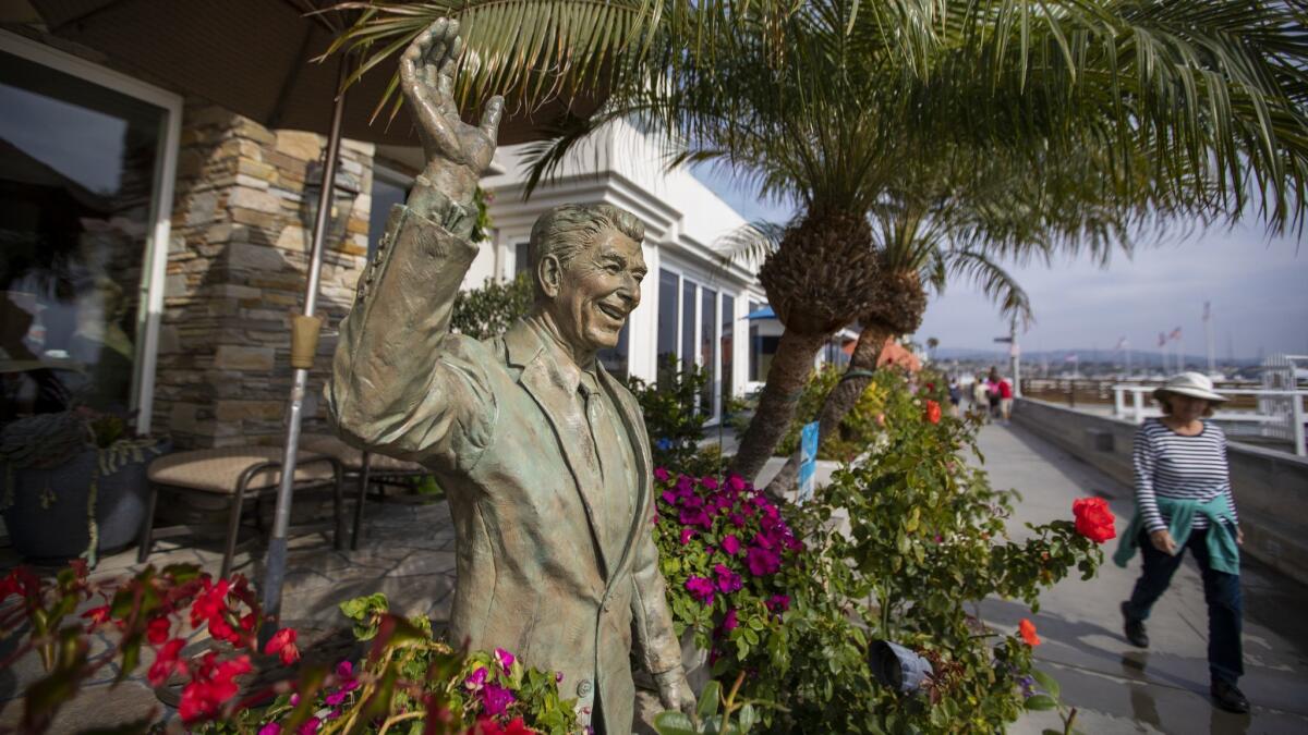A statue of President Reagan adorns a Balboa Island waterfront home in Newport Beach. U.S. Rep. Dana Rohrabacher, facing a serious challenge for the first time in 30 years, was a speechwriter for Reagan.